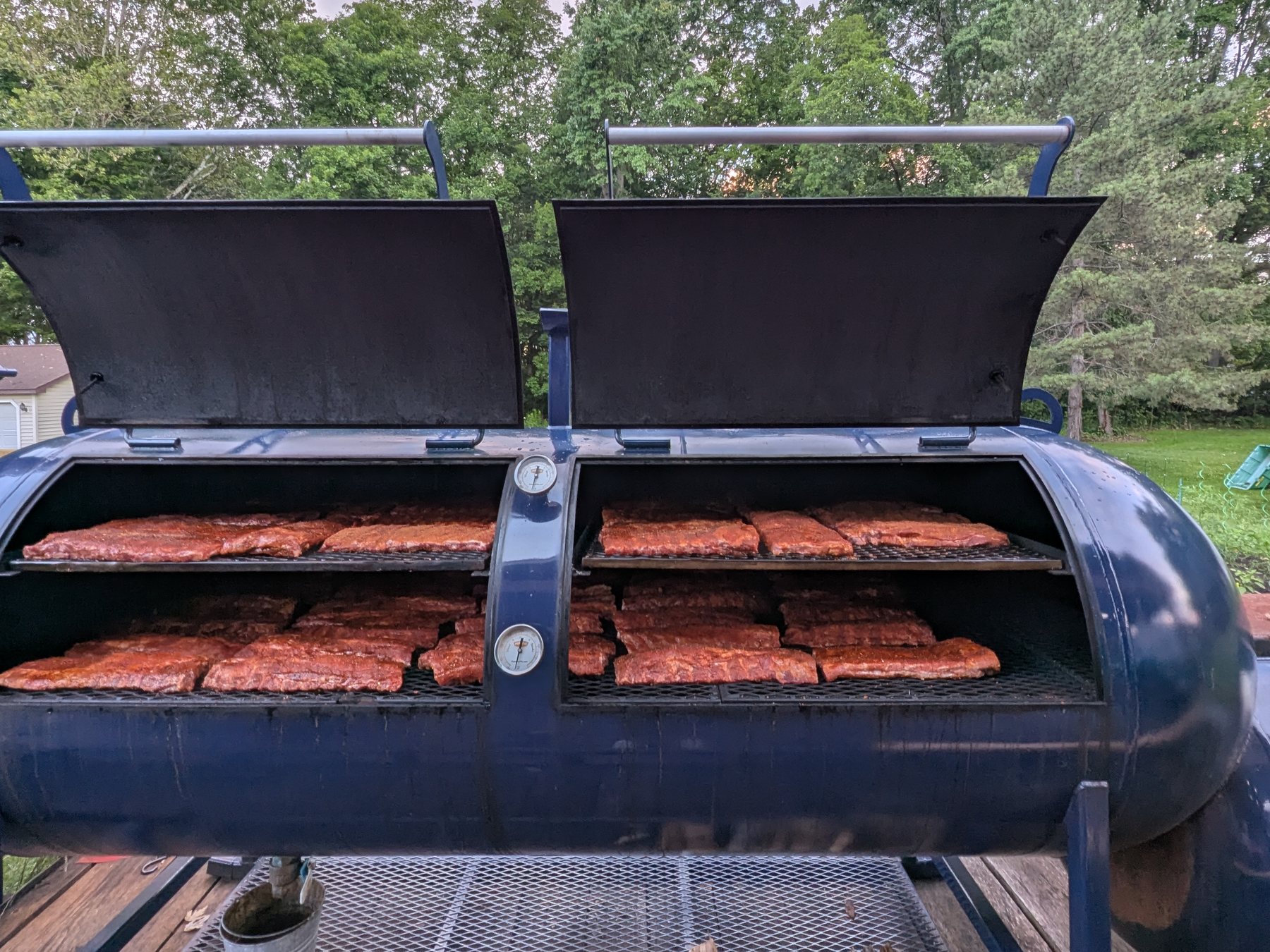 Fifty-seven slabs of spare ribs on the 500-gallon Primitive Pits offset smoker
