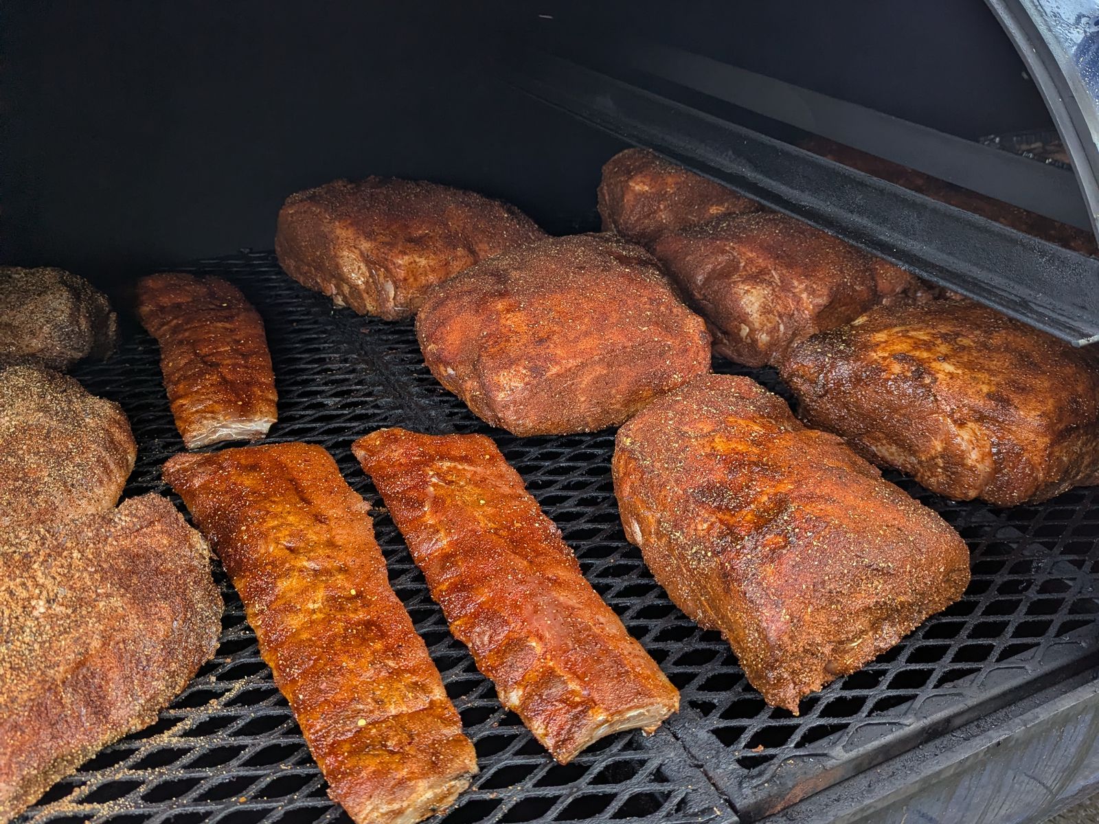 Spare ribs and pork butts smoking together on the offset
